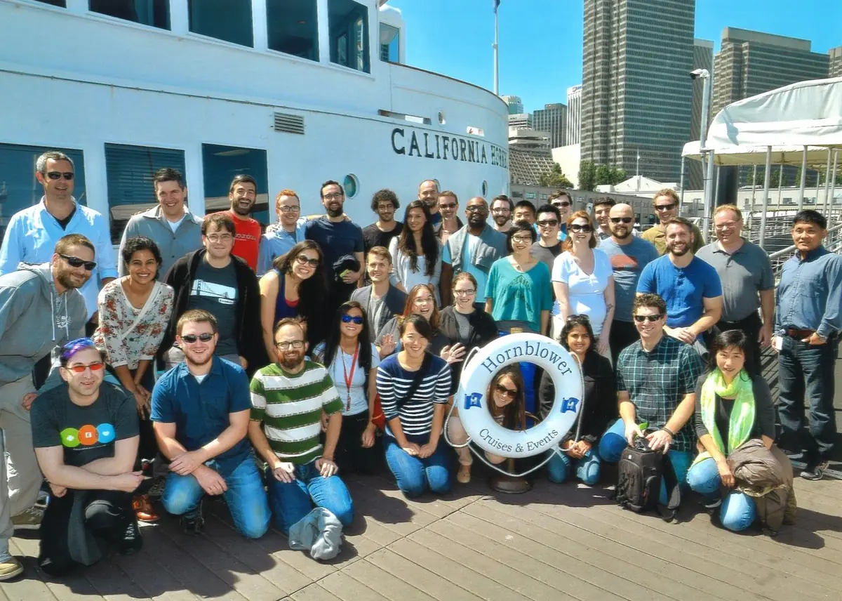 A large product and design team gathered by the water for a team outing